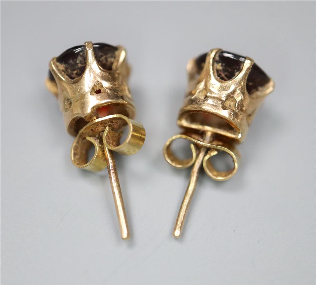 A pair of yellow metal and garnet set earstuds, gross 1.9 grams(a.f.).